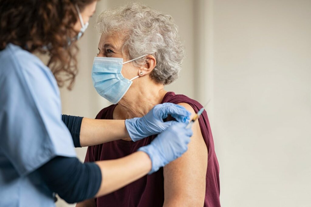 Doctor gives senior woman Covid vaccine