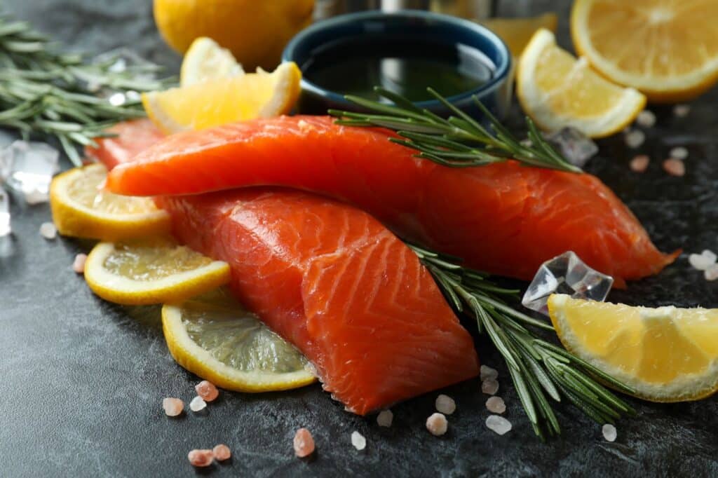 Two slices of salmon with rosemary and lemon