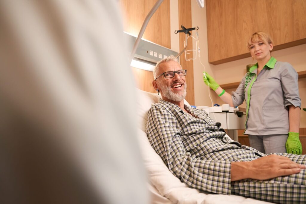 A kidney patient getting dialysis in a hospital bed