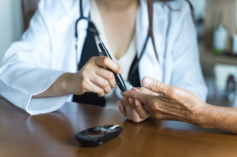 kidney and diabetes specialist checks patients blood sugar
